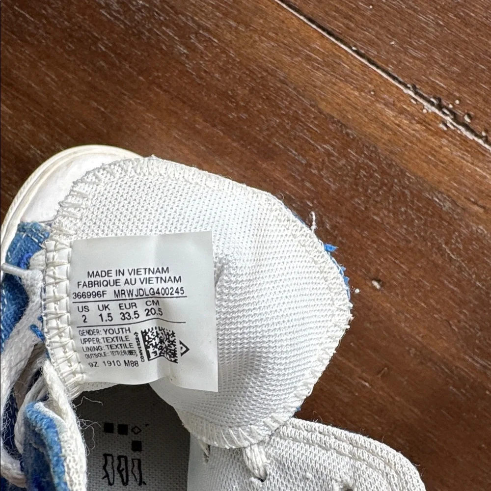 Size 2 Converse Chuck Taylor All Star Sneakers on blue